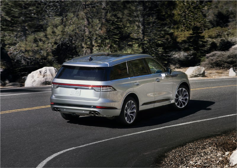 A 2023 Lincoln Aviator® Grand Touring model is shown being driven on a tight turn of a mountain road | Bondy's Lincoln in Dothan AL