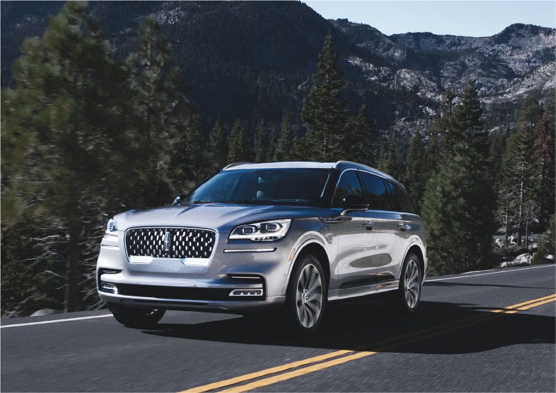 A 2023 Lincoln Aviator® Grand Touring SUV being driven on a winding road to demonstrate the capabilities of all-wheel drive | Bondy's Lincoln in Dothan AL