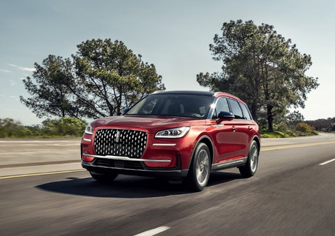 A 2024 Lincoln Corsair® SUV is shown being driven on a country road. | Bondy's Lincoln in Dothan AL