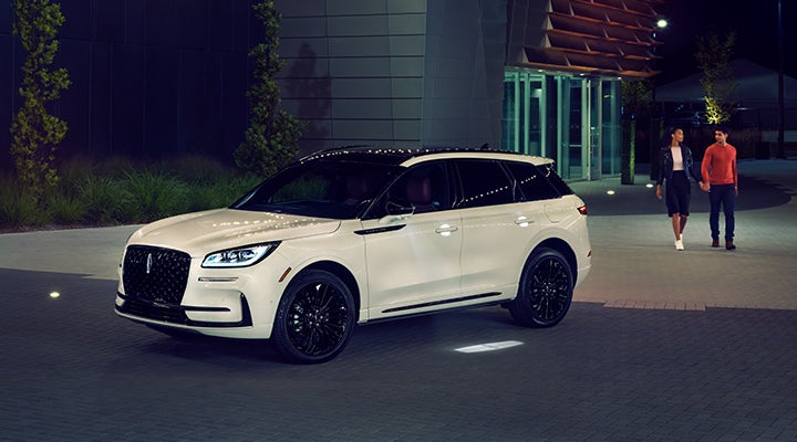 Two people approach a 2024 Lincoln Corsair® SUV featuring the available Jet Appearance Package. | Bondy's Lincoln in Dothan AL