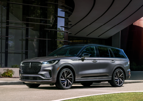 A gray 2025 Lincoln Aviator® SUV is parked outside a modern building showcasing the driver’s side of the vehicle. | Bondy's Lincoln in Dothan AL