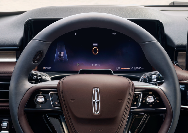 The steering wheel of 2025 Lincoln Aviator® SUV is shown with black and brown accents. | Bondy's Lincoln in Dothan AL