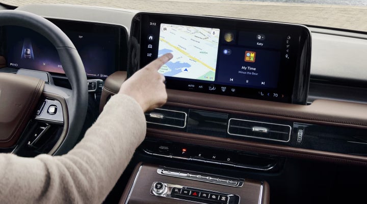 A person is tapping the center display touchscreen of a 2026 Lincoln Aviator® SUV. | Bondy's Lincoln in Dothan AL