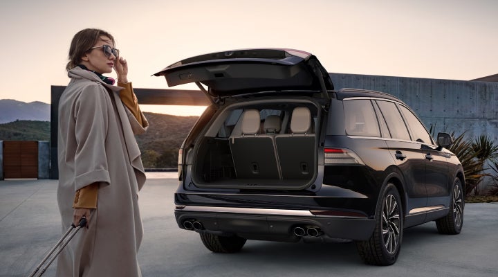 A woman approaches a 2026 Lincoln Aviator® SUV with its rear liftgate open. | Bondy's Lincoln in Dothan AL