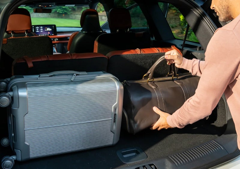 A man loads luggage into the rear of a 2026 Lincoln Aviator® SUV through the opened rear liftgate. | Bondy's Lincoln in Dothan AL
