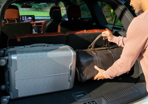 A man loads luggage into the rear of a 2026 Lincoln Aviator® SUV through the opened rear liftgate. | Bondy's Lincoln in Dothan AL