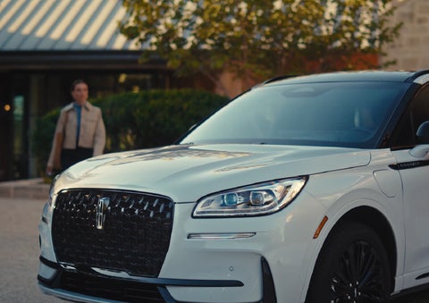 A person approaches a 2026 Lincoln Corsair® SUV as the Lincoln Embrace light sequence takes place. | Bondy's Lincoln in Dothan AL