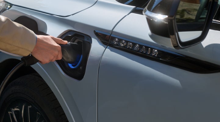 A hand is plugging in a 2026 Lincoln Corsair® Grand Touring Plug-in Hybrid SUV. | Bondy's Lincoln in Dothan AL