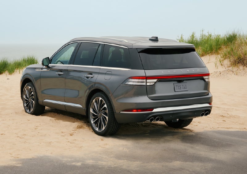 A 2027 Lincoln Aviator® SUV is parked next to sand dunes. | Bondy's Lincoln in Dothan AL
