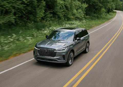 A 2027 Lincoln Aviator® SUV is being driven down a road. | Bondy's Lincoln in Dothan AL