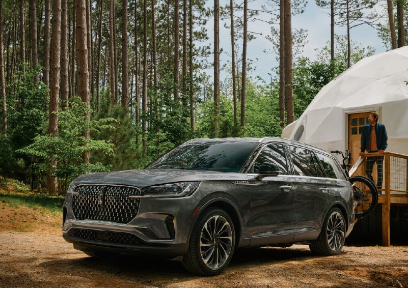 A 2027 Lincoln Aviator® is parked next to a high end glamping site. | Bondy's Lincoln in Dothan AL