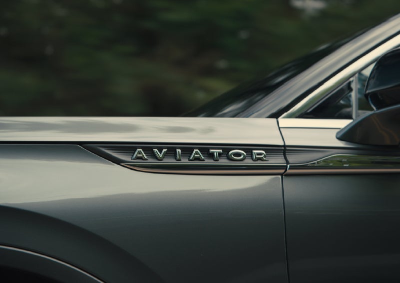 The driver’s side door and fender badging of a gray 2027 Lincoln Aviator® SUV are showcased. | Bondy's Lincoln in Dothan AL
