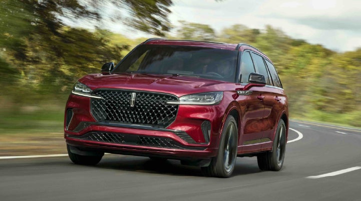 A 2027 Lincoln Aviator® SUV is being driven on a country road | Bondy's Lincoln in Dothan AL