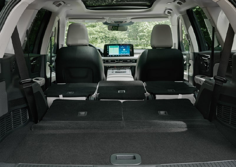 A rear to front view of the interior of a 2027 Lincoln Aviator® Black Label™ SUV shows the third and second rows folded flat | Bondy's Lincoln in Dothan AL