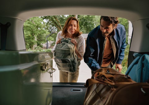 A couple loads luggage into the rear of a 2027 Lincoln Aviator® Black Label™ SUV..e 202 | Bondy's Lincoln in Dothan AL